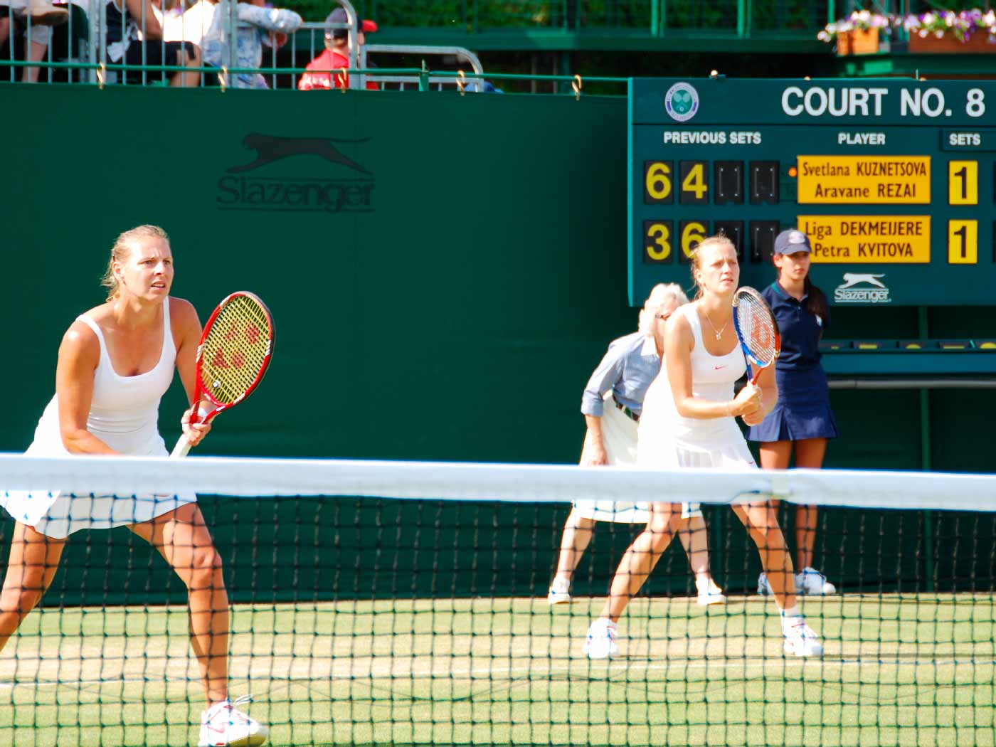 Liga Dekmeijere and Petra Kvitova playing doubles at Wimbledon.